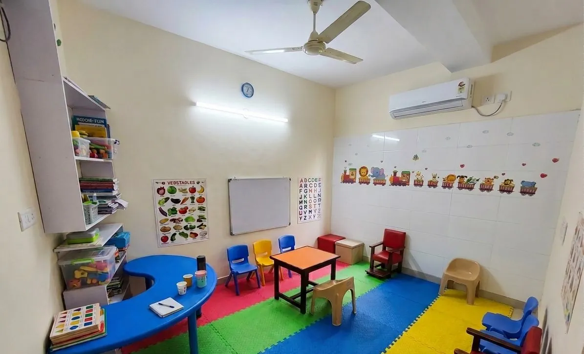 Sensory and occupational therapy room with swings, soft play mats and therapy equipment.