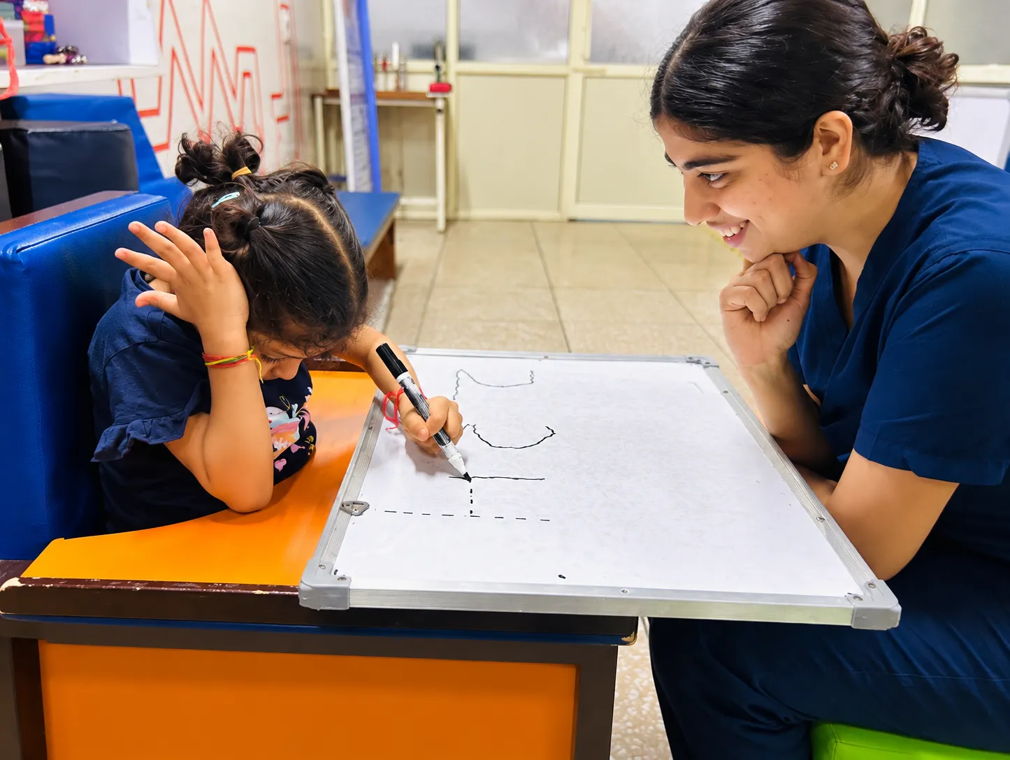 An OT Cloud therapist carrying out an assessment activity with a child.